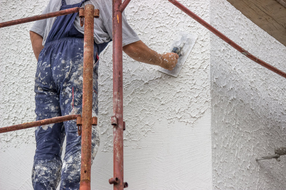 Man performing a plastering service