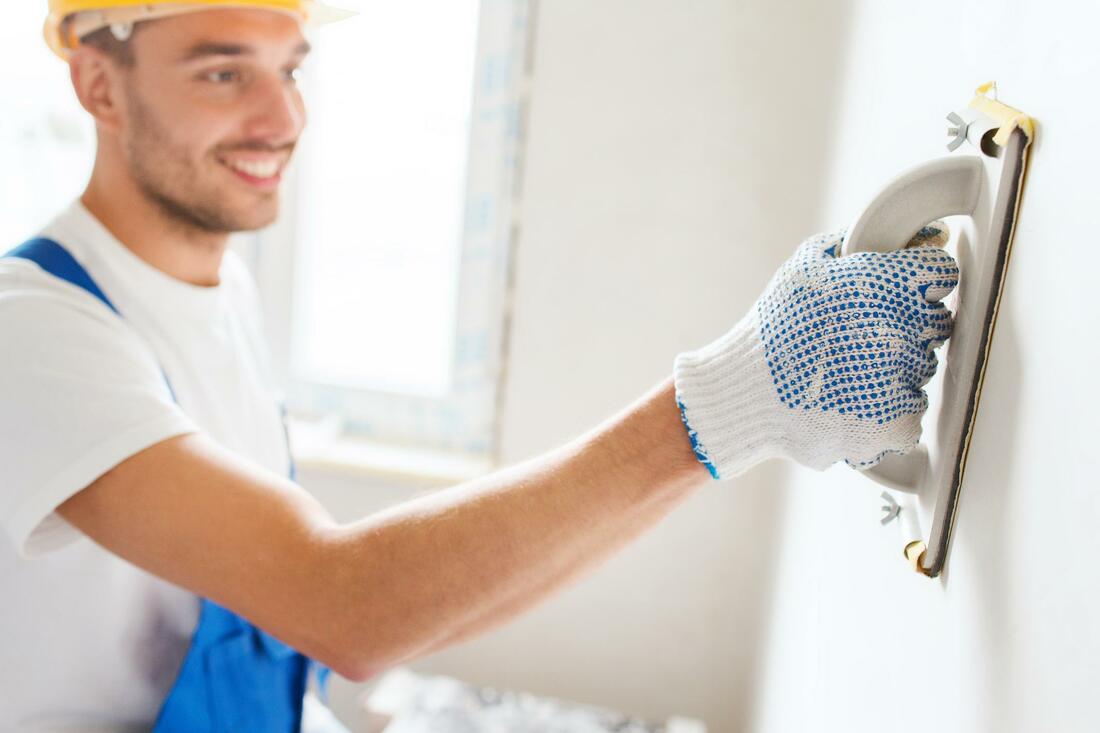 Man performing a plastering service